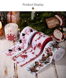 Close-up of Christmas decorative ribbons with snowman and Santa prints on white wood table