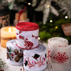Close-up of festive Christmas ribbons with Santa and snowman patterns on wooden table