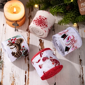 Detailed view of four festive Christmas ribbons with snowflakes and Santa on wood background