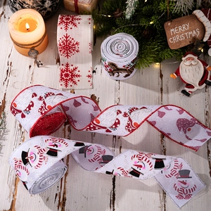 Close-up of assorted Christmas ribbons with snowman and snowflake patterns on wood