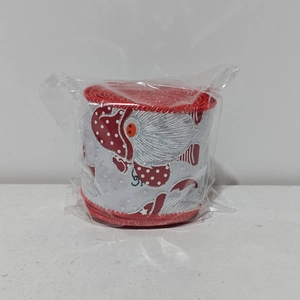 Detail of red and white Christmas ribbon roll with polka dot pattern in plastic wrap