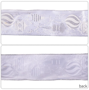 Detail of lavender Christmas ribbon showing silver glitter patterns and back texture