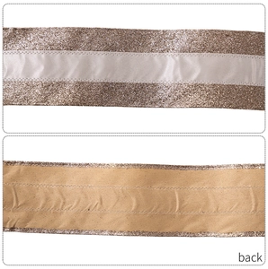 Detail showing high-end champagne gold sequin ribbon with white satin center and twill back
