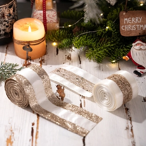Detail of luxury gold glitter ribbons on a festive wooden surface for Christmas decoration