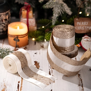 Detail of luxury gold Christmas ribbons with glitter mesh for festive gift wrapping