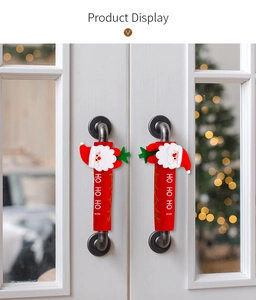 Detail of Christmas Santa handle covers with HO HO HO text on a white door handle
