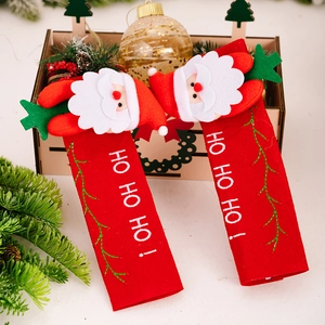 Detail of red Christmas handle covers with Santa plush and HO HO HO embroidery