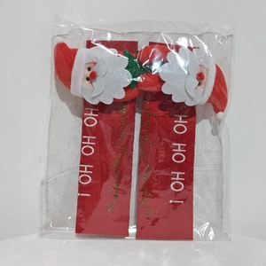Detail of Christmas handle covers featuring Santa Claus figurines and HO HO HO embroidery