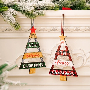 Détail de suspensions de Noël rustiques en bois avec motifs à carreaux sur cheminée