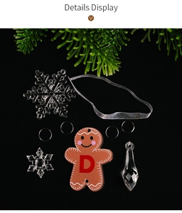 Detail view of acrylic snowflake and gingerbread man ornaments for Christmas tree decor