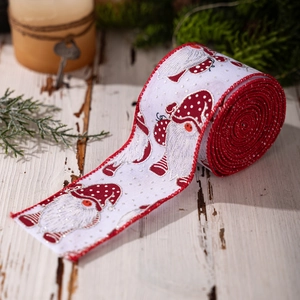 Christmas ribbon with gnome and polka dot patterns on rustic wooden background