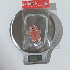 Gingerbread man acrylic pendant for Christmas tree decor weighing 16.5g on a scale