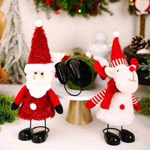 Detail of plush Santa and reindeer Christmas dolls with long metal spring legs on display