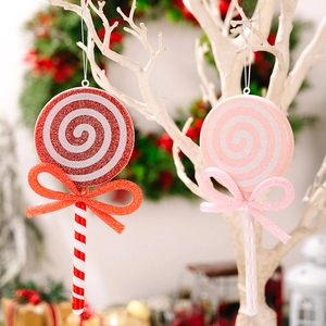 Detail of red and pink glittery Christmas lollipop ornaments with bows on a tree