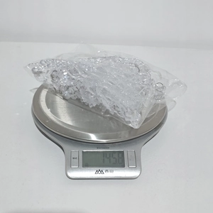 Macro detail of acrylic Christmas ornaments in bulk showing weighing of 145.8g
