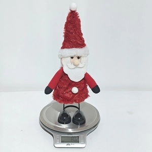 Detailed view of a Santa plush doll on a scale weighing approximately 80.2 grams