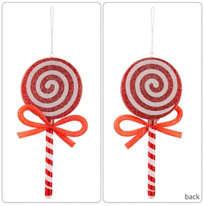 Macro view of Christmas lollipop ornament with red bow and glitter texture