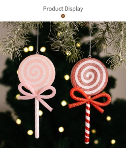 Close-up of candy cane ornaments with bows on a Christmas tree branch