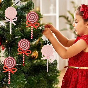 Close-up of red and pink glitter lollipop ornaments with mesh bows on a Christmas tree