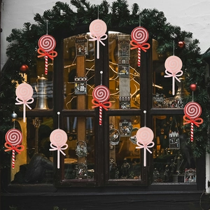 Detail of Christmas lollipop ornaments with spiral patterns and festive pink bows