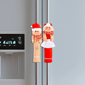 Detailed view of gingerbread man and girl covers on silver refrigerator handles