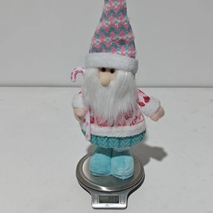 Pink Christmas gnome plush toy weight measurement detail showing 347 grams on a digital scale