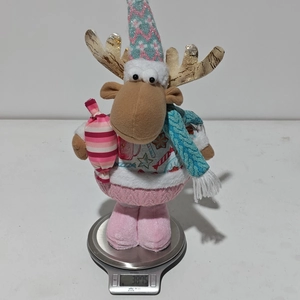 Pink Christmas reindeer doll weight measurement on scale showing 387.5g detail