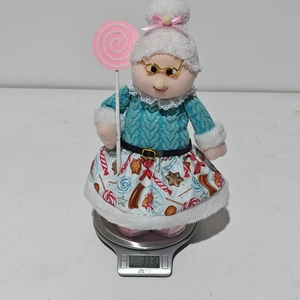 Pink Christmas doll grandma plush weight measurement detail on electronic scale