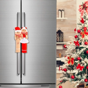 Close-up of gingerbread man refrigerator handle covers on silver fridge door