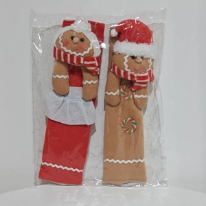 Detail of gingerbread man Christmas refrigerator handle covers with festive decorations