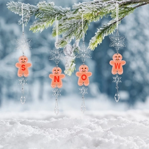 Set of 4 acrylic gingerbread man SNOW ornaments hanging on a snowy Christmas tree