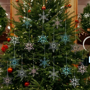 Macro detail of acrylic Christmas snowflakes in pink and blue hanging on a tree