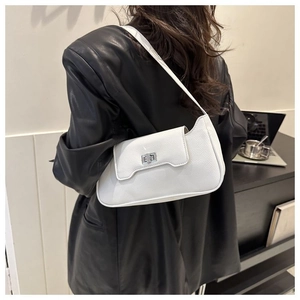 Chic white leather shoulder bag with silver clasp closure shown on a model's shoulder
