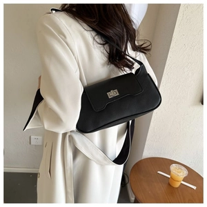 Detail showing back view of black lychee leather shoulder bag with silver twist lock