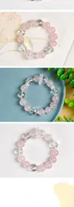 Detail of 13mm pink rose quartz and white crystal bead bracelet with silver bow charm