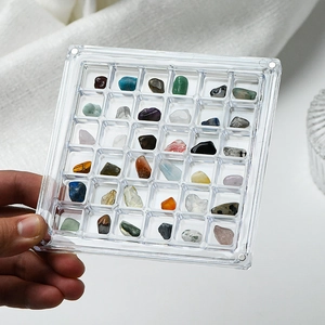 36-grid acrylic mineral specimen box with natural crystals held in hand for display