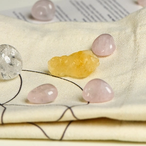 Natural crystal stone set with rose quartz and citrine on a geometric cotton pouch