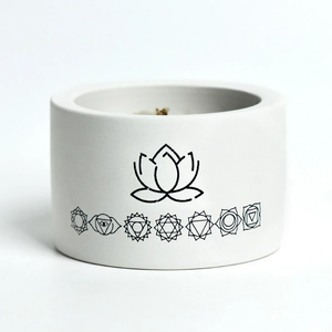 Minimalist white ceramic soy candle jar featuring lotus and seven chakra symbols design