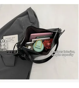 Interior view of large black leather shoulder bag showing ample space and daily essentials
