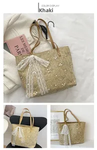Detail view of khaki straw tote bag featuring floral embroidery and lace bow decoration