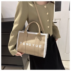 Détail du sac cabas en cuir marron clair avec bordure en peluche et logo TENG YUE