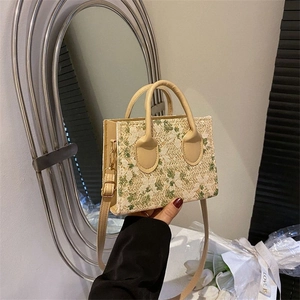 Mini woven bag with green floral lace embroidery and adjustable crossbody shoulder strap