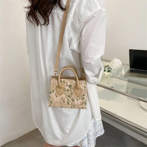 Mini floral woven crossbody bag with leather straps and delicate lace accents