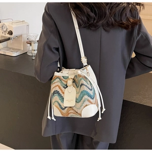 Detail of bohemian bucket bag featuring wave pattern fabric and drawstring closure