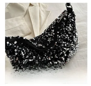 Close-up of black bucket bag with shimmering silver sequins and sleek zipper closure
