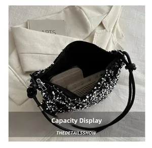 Detail view of the black sequin bucket bag capacity showing interior storage space