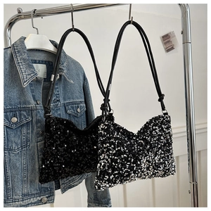 Detailed view of shimmering sequins and knotted strap design on black and silver bucket bags