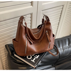 Détail du sac cabas en similicuir marron vintage avec fermetures éclair argentées
