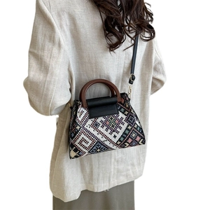 Ethnic woven tote with geometric patterns, wooden handles and crossbody strap