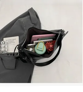 Interior view of black leather tote bag showcasing high capacity for tablets and daily items